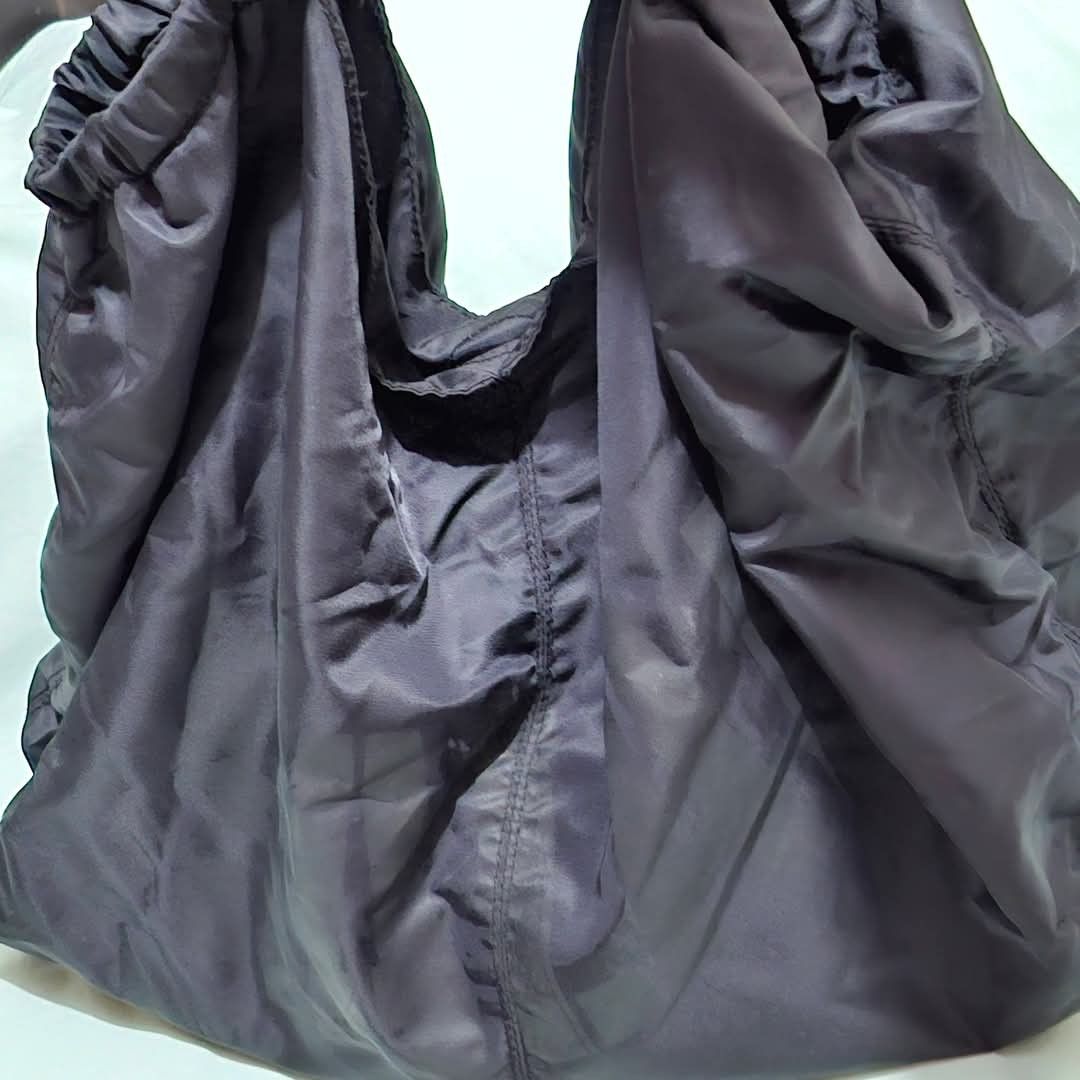 SALAD-Black Nylon Slouchy Shoulder Bag (Category: Shoulder Bags) located in Manila. Submitted by closetprincess (Listing ID 1469245168, Image 3). Description: - Color: Black - Material: Durable, lightweight nylon - Design: Soft, unstructured slouchy bag with gathered elastic openings and center vertical seam - Straps: Dual thin carrying straps - Compartment: Deep main compartment, perfect for daily essentials - Feature: Folds completely flat when