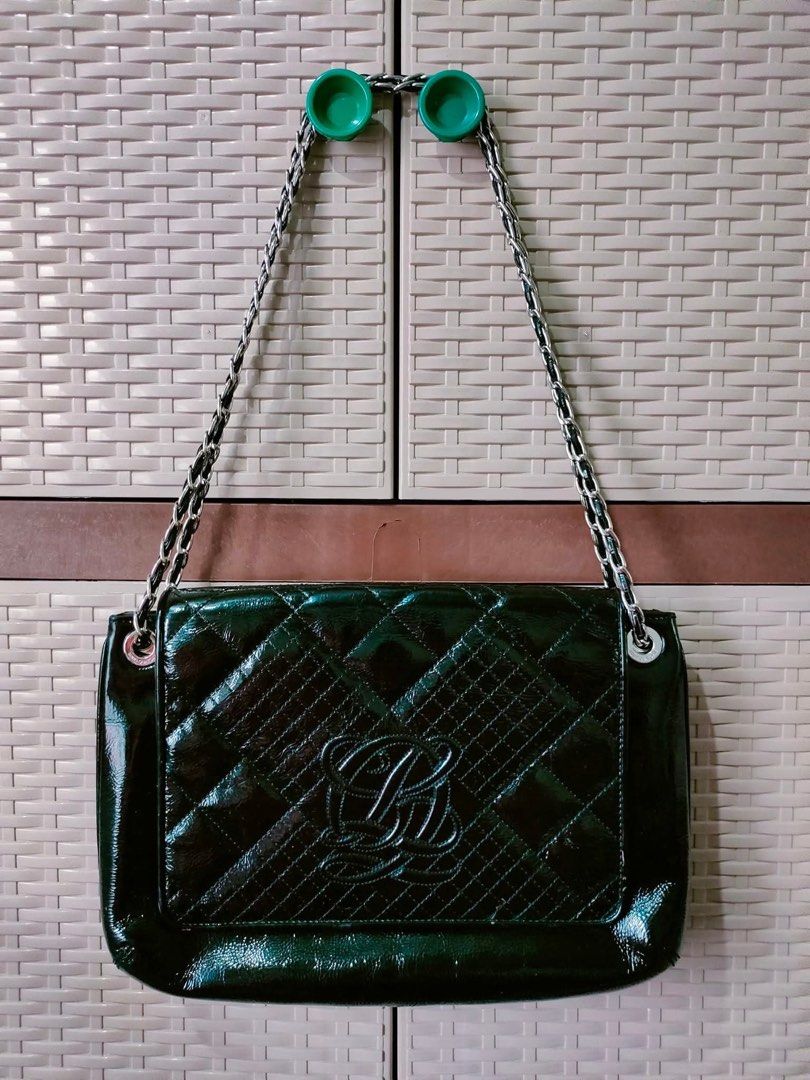 Black Quilted Patent Leather Chain Shoulder Bag (Category: Shoulder Bags) located in Manila. Submitted by ekailacerna (Listing ID 1469316210, Image 1). Description: - Color/Finish: Black patent leather with a glossy quilted look - Hardware & Strap: Silver chain strap threaded with leather - Design: Large embossed logo on the front flap - Interior: Spacious compartment with a clean lining - Condition: Minor wear on the patent surface, well-maintai