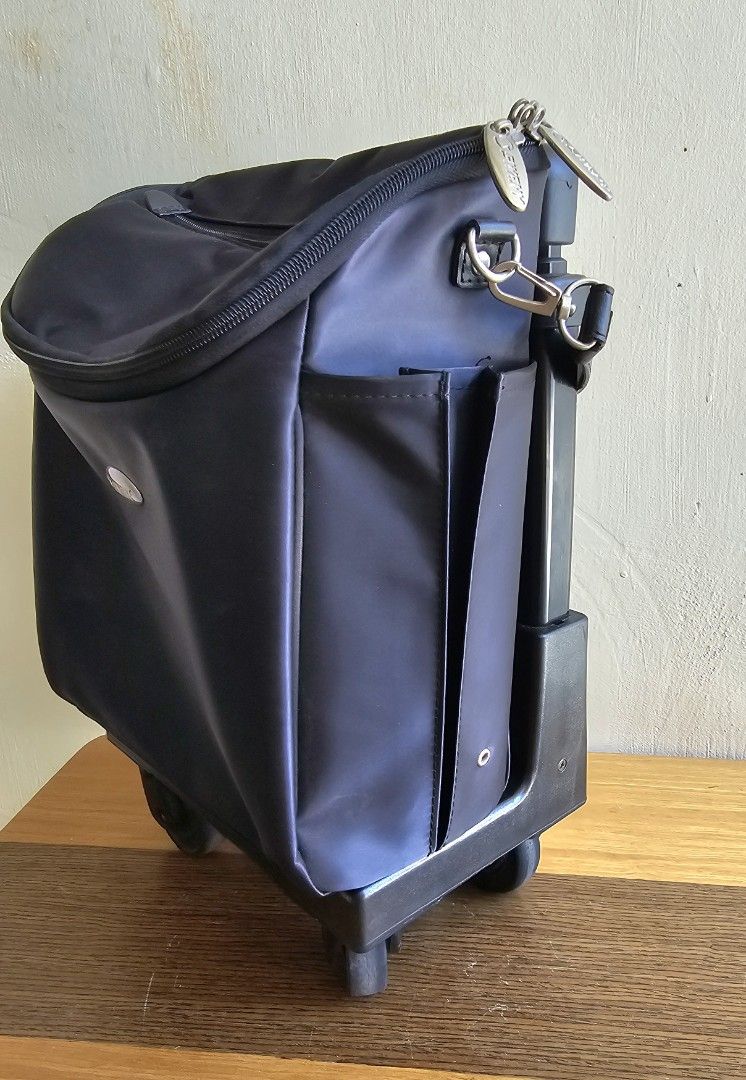 Black Rolling Trolley Bag with Retractable Handle (Category: Luggage) located in Meycauayan. Submitted by amazinggrace_143 (Listing ID 1469291450, Image 3). Description: - Color: Sleek black - Material: Durable nylon - Mobility: Sturdy retractable handle and smooth rolling wheels - Organization: Multiple inner and outer compartments plus side pockets for water bottles - Size: Compact, fits overhead storage - Best for: Travel and daily commutes.