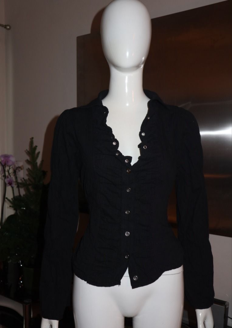 Black Ruffled Long Sleeve Button Down Shirt (Category: Longsleeves) located in Paranaque City. Submitted by skulkch (Listing ID 1469362210, Image 2). Description: - Color: Black - Style: Button-down blouse with ruffled lapels - Details: Silver-tone front buttons, long sleeves, fitted cut - Versatility: Perfect for casual or formal wear - Condition: Excellent / Well-maintained.