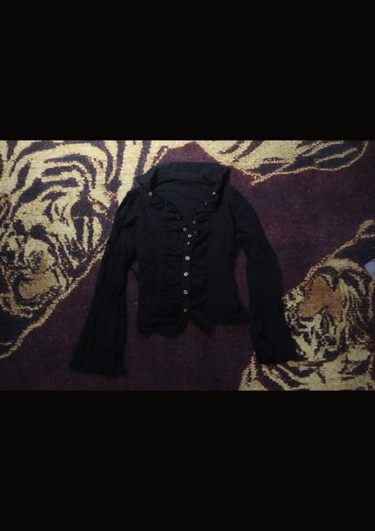 Black Ruffled Long Sleeve Button Down Shirt (Category: Longsleeves) located in Paranaque City. Submitted by skulkch (Listing ID 1469362210, Image 3). Description: - Color: Black - Style: Button-down blouse with ruffled lapels - Details: Silver-tone front buttons, long sleeves, fitted cut - Versatility: Perfect for casual or formal wear - Condition: Excellent / Well-maintained.