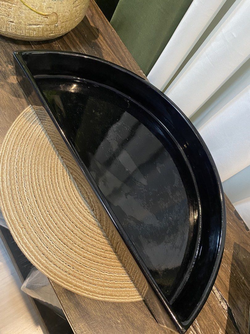 Black semicircular decorative tray ceramic dish (Category: Dinnerware & Cutlery) located in San Pedro. Submitted by jingay81 (Listing ID 1469375539, Image 2). Description: - Half-circle black ceramic tray with a sleek glossy finish - Generous 16-inch width, ideal for console or coffee tables - Flat base with raised curved edges to keep items secure - Versatile use: perfect for holding small decor, candles, or vanity essentials - Solid black desig