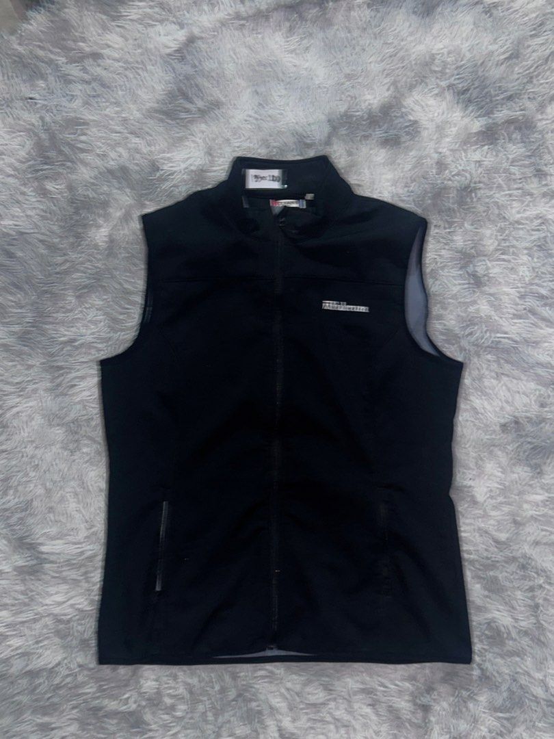 Black sleeveless zip-up vest jacket (Category: Sleeveless) located in Caloocan City. Submitted by sinnr.vault (Listing ID 1469256990, Image 1). Description: - Color: Black - Style: Sleeveless zip-up vest with a high collar - Material: Lightweight, soft softshell fabric - Pockets: Convenient zippered front pockets - Branding: Minimalist logo on the left chest - Fit: Standard fit for easy layering - Ideal For: Cooler weather, morning runs, and outd
