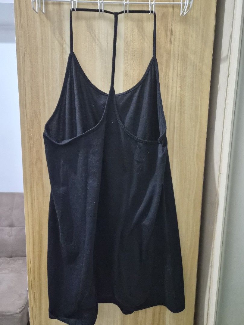 Black Spaghetti Strap Tank Top Cami (Category: Sleeveless) located in Mandaluyong City. Submitted by joyce1593 (Listing ID 1469255274, Image 2). Description: - Color: Black - Style: Spaghetti straps, racerback with horizontal back strap detail - Fabric: Soft, stretchy, and comfortable - Versatile: Easy to pair with jeans, shorts, or skirts - Condition: Brand new / Excellent.