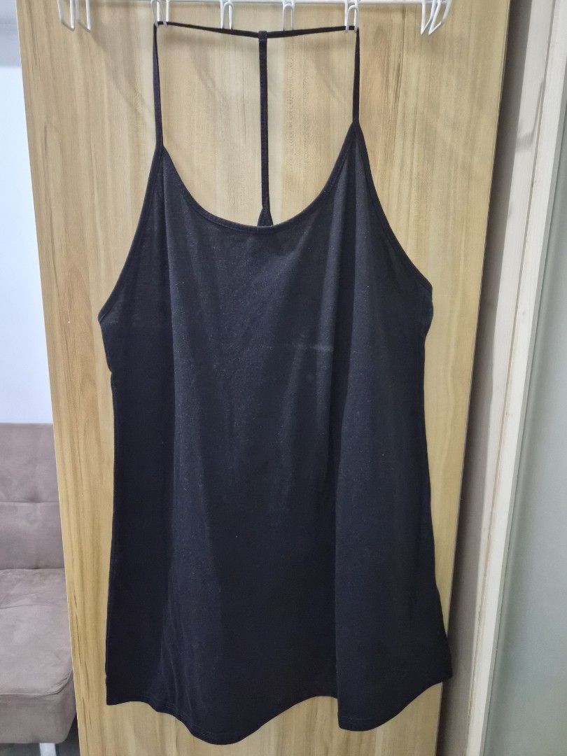 Black Spaghetti Strap Tank Top Cami (Category: Sleeveless) located in Mandaluyong City. Submitted by joyce1593 (Listing ID 1469255274, Image 1). Description: - Color: Black - Style: Spaghetti straps, racerback with horizontal back strap detail - Fabric: Soft, stretchy, and comfortable - Versatile: Easy to pair with jeans, shorts, or skirts - Condition: Brand new / Excellent.
