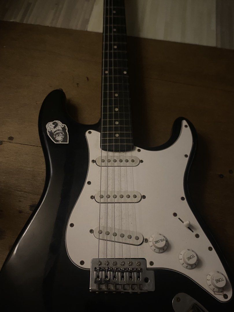 Black Stratocaster Style Electric Guitar (Category: Musical Instruments) located in Manila. Submitted by 4everch1ro (Listing ID 1469344745, Image 1). Description: - Stratocaster-style electric guitar in classic black with a white pickguard - visible rust on screws, pickup poles, and bridge - Rushed sale, PM for inquiries! INCLUSIONS : Guitar Bag Amp cord Loc : Malate, Manila RFS: need funds for ipad :C.