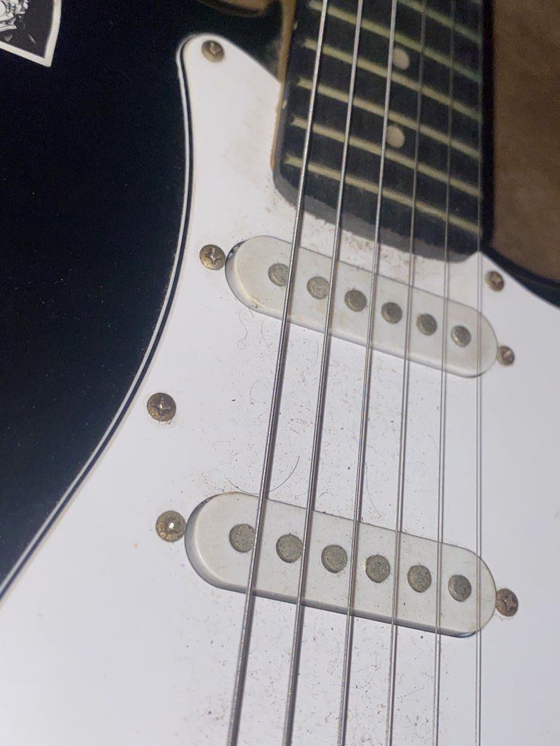 Black Stratocaster Style Electric Guitar (Category: Musical Instruments) located in Manila. Submitted by 4everch1ro (Listing ID 1469344745, Image 3). Description: - Stratocaster-style electric guitar in classic black with a white pickguard - visible rust on screws, pickup poles, and bridge - Rushed sale, PM for inquiries! INCLUSIONS : Guitar Bag Amp cord Loc : Malate, Manila RFS: need funds for ipad :C.