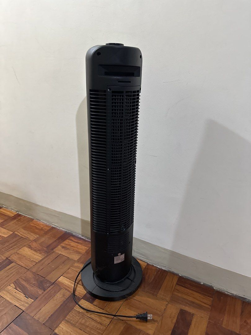 Blakk Black Tower Fan (Category: Fans) located in Quezon City. Submitted by jeps-sells (Listing ID 1469241648, Image 2). Description: - Brand: Blakk - Type: Slim vertical tower fan - Color: Black - Base: Sturdy round base for stability - Power: Standard wall plug cord included - Condition: Good working condition with minor dust near the bottom vent due to normal daily use - Best for: Cooling living spaces and bedrooms without taking up much floor