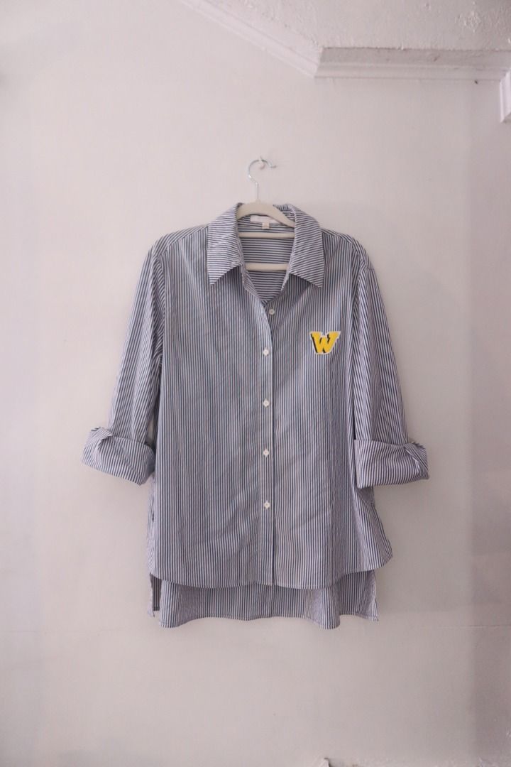 Blue and white striped button-down polo shirt (Category: Tshirts & Polo Shirts ) located in Manila. Submitted by imama23 (Listing ID 1469196857, Image 2). Description: - Fit: Relaxed long sleeves with a high-low curved hem and side slits Condition: 7/10 Size: XS on tag but best fits S-M Location: Manila (near taft) 📦 SHIPPING • Full payment before shipping • NCR: J&T (1–3 days) / Grab or Lalamove (same-day) • Provincial: J&T (1–7 days) • Shippin