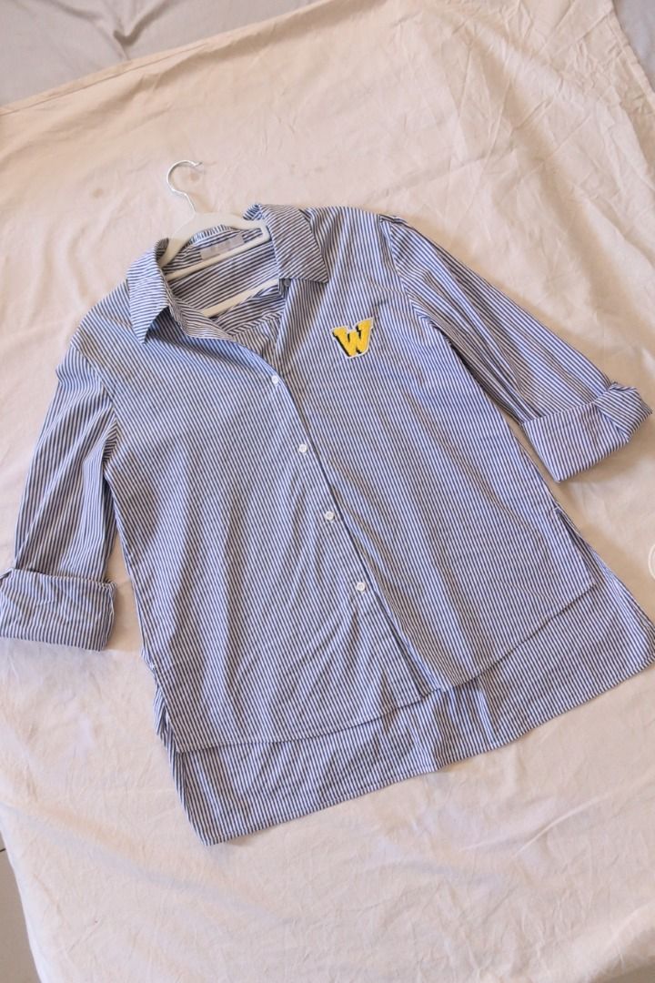 Blue and white striped button-down polo shirt (Category: Tshirts & Polo Shirts ) located in Manila. Submitted by imama23 (Listing ID 1469196857, Image 1). Description: - Fit: Relaxed long sleeves with a high-low curved hem and side slits Condition: 7/10 Size: XS on tag but best fits S-M Location: Manila (near taft) 📦 SHIPPING • Full payment before shipping • NCR: J&T (1–3 days) / Grab or Lalamove (same-day) • Provincial: J&T (1–7 days) • Shippin