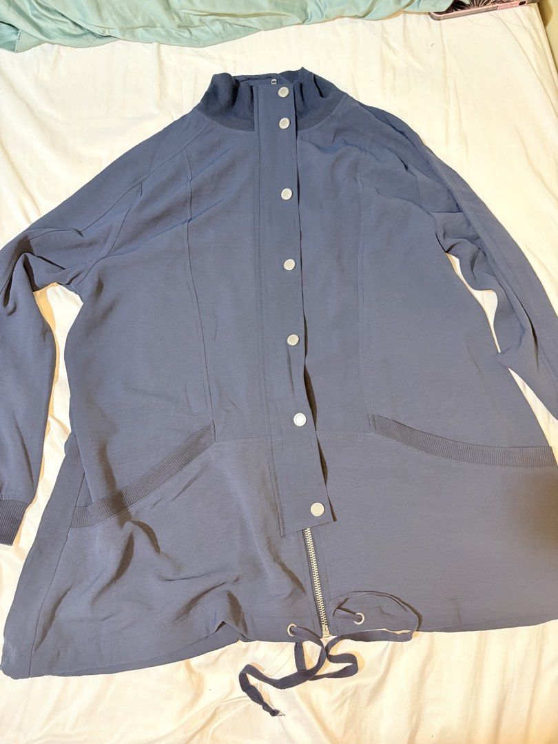 Blue Grey Casual Long Jacket With Drawstring Hem (Category: Coats, Jackets and Outerwear) located in Manila. Submitted by thriftwithgem (Listing ID 1469254231, Image 1). Description: - Color: Blue grey - Closure: Snap buttons and lower zipper front - Collar: High mock neck - Pockets: Two angled front pockets with ribbed trim - Hem: Adjustable drawstring for a custom fit - Style: Lightweight, casual layer ideal for everyday wear.