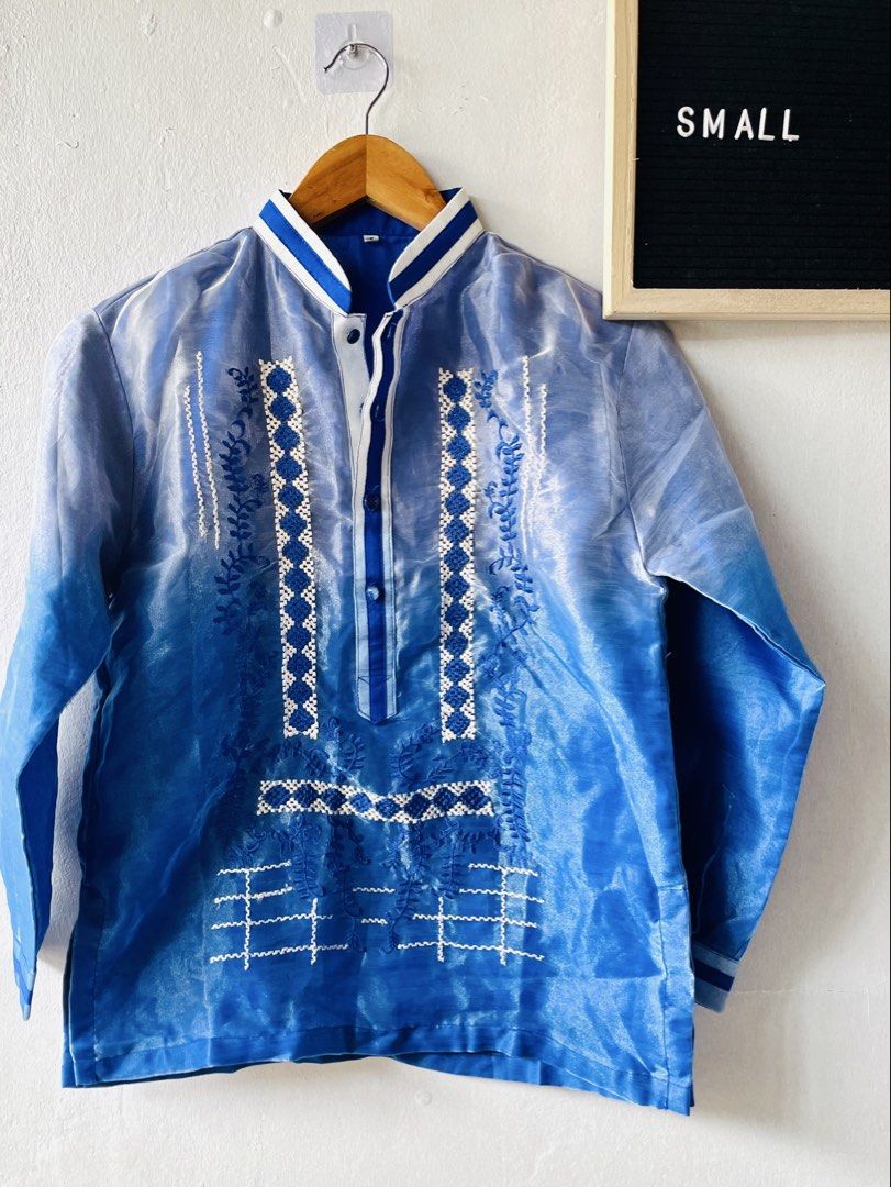 Blue Mandarin Collar Embroidered Barong Tagalog (Category: Formal Shirts) located in Caloocan City. Submitted by lovemyclothes21 (Listing ID 1469268728, Image 2). Description: - Eye-catching blue ombre design with intricate white and blue embroidery - Elegant mandarin collar and long sleeves with matching striped trim - Classic button-up front placket - Traditional sheer fabric featuring detailed geometric and floral patterns - Ideal for weddings