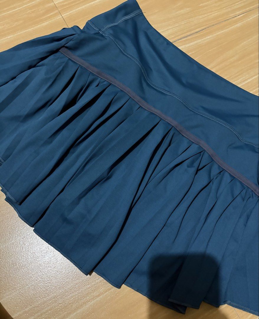 Blue Pleated Athletic Skort with Built-in Shorts (Category: Skirts) located in Caloocan City. Submitted by stella_mari27 (Listing ID 1469229975, Image 3). Description: - Color: Dark blue - Style: Pleated athletic skort with built-in shorts - Comfort: Wide waistband for extra support and coverage - Ideal for: Tennis, running, gym workouts, and active lifestyle - Condition: Clean fabric, no stains or loose threads, ready to wear.