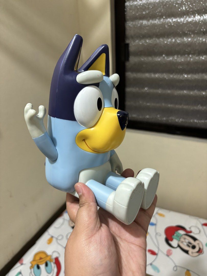 Bluey Action Figure Toy Poseable Character (Category: Figurines & Statues) located in Makati City. Submitted by jhonnared (Listing ID 1469174333, Image 3). Description: - Official Bluey character toy with classic smiling face - Movable arms and legs (can sit or stand) - Stands upright on its own without falling over - Ideal for playtime or shelf display - Condition: Has minor paint scuff marks from regular play.