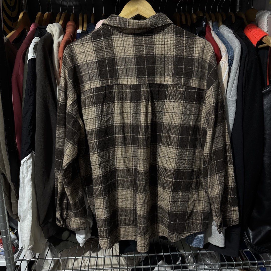 Brown Plaid Flannel Shirt Oversized Width 24 Length 27 (Category: Coats, Jackets and Outerwear) located in Caloocan City. Submitted by bonsatocha43876 (Listing ID 1469322112, Image 2). Description: - Color/Pattern: Brown and beige plaid - Style: Button-up flannel shirt with dual chest pockets - Size: 24" width x 27" length - Condition: Very good overall, clean fabric, complete tags attached - Status: Ready to wear.
