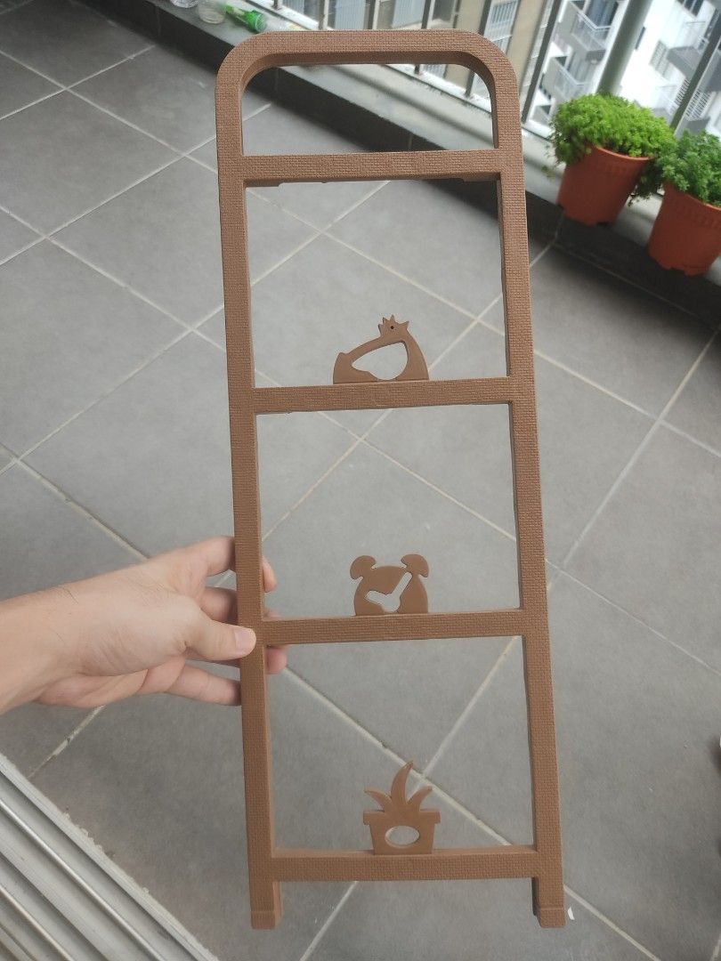 Brown plastic stackable rack shelf (Category: Shelves, Cabinets & Racks) located in Kuala Lumpur. Submitted by ooikeesiong (Listing ID 1469164817, Image 3). Description: - Brown multi-tier shoe rack with adorable animal cutouts on the side panels - Sturdy metal rods provide strong support - Excellent space-saving design, ideal for entryways and corridors - Clean condition and 100% complete with all parts included - Packed flat for easy transport 