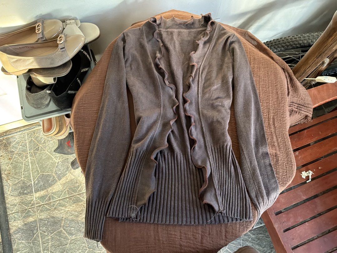 Brown Ruffle Trim Open Cardigan Sweater (Category: Coats, Jackets and Outerwear) located in Dumaguete. Submitted by _l1lyy_ (Listing ID 1469246666, Image 3). Description: - Fits small to medium frames - Color: Brown - Style: Open-front cardigan - Details: Playful ruffle trim along neckline and placket - Texture: Ribbed knit on long sleeves and lower hem - Material: Soft and comfortable - Fit: Versatile layering piece, ideal for cooler weather.