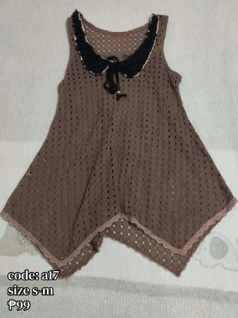 Brown sleeveless crochet top with black collar code a17 (Category: Sleeveless) located in Carmona. Submitted by ichorvault (Listing ID 1469285688, Image 1). Description: - Style: Sleeveless brown crochet knit top with openwork pattern - Details: Black fabric collar with scalloped trim and neckline tie - Hem: Asymmetrical handkerchief hem trimmed with lace - Fabric: Airy, lightweight, and comfortable - Fit: Small to Medium - Perfect for pairing wi
