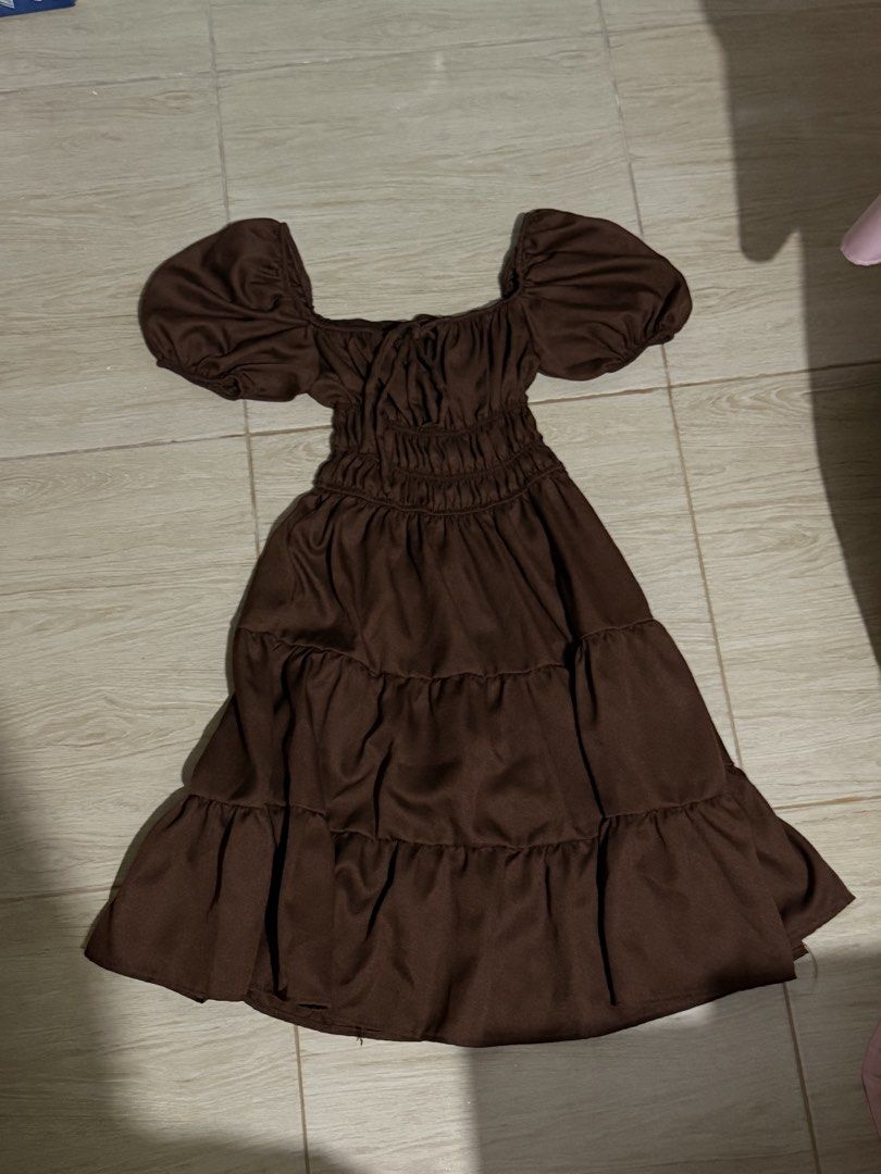 Brown Tiered Puff Sleeve Mini Dress (Category: Dresses) located in Solano. Submitted by blkcat1221 (Listing ID 1469262371, Image 2). Description: - Color: Rich brown with a smooth sheen - Design: Puffy short sleeves, tiered skirt, and ruched bodice with neckline tie - Versatility: Ideal for beach trips or casual day outs - Condition: Worn only once, practically spotless.
