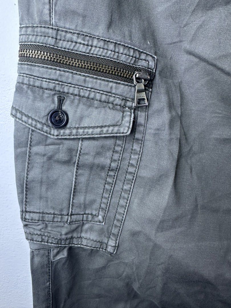 Burberry Black Label Cargo Pants Green (Category: Joggers) located in Manila. Submitted by declutterpromax (Listing ID 1469223228, Image 3). Description: - Brand: Burberry Black Label - Color: Olive Green - Fit: Straight leg - Material: Sturdy twill fabric - Features: Multiple utility pockets with button and zip closures, rear buttoned pockets, and branded hardware zipper pulls - Condition: Excellent pre-owned condition (Ready to wear) - Mode of 