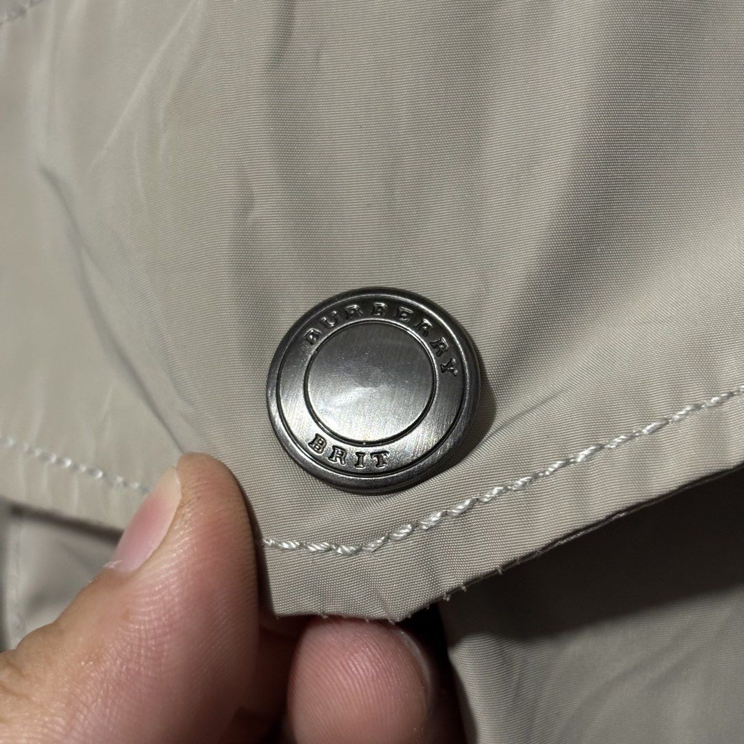 Burberry Brit Beige Hooded Jacket (Category: Coats, Jackets and Outerwear) located in Caloocan City. Submitted by bonsatocha43876 (Listing ID 1469323187, Image 3). Description: - Authentic Burberry Brit hooded jacket in classic beige - Brand new with complete tags attached - Features multiple front pockets with secure snap buttons - Premium branded hardware details - Iconic signature check pattern lining - Width: 24 inches - Length: 31 inches.