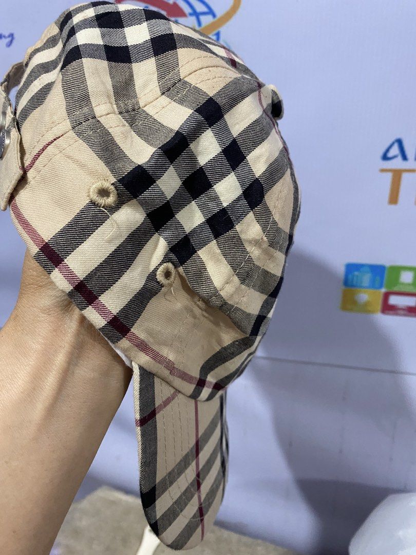 Burberry London Classic Check Cap (Category: Caps & Hats) located in Bacolod City. Submitted by chuchaystuffs (Listing ID 1469217634, Image 2). Description: - Brand: Burberry London - Pattern: Classic beige, black, and red check - Size: One size fits all with adjustable strap - Hardware: Silver-tone metal snap buttons with Burberry logo - Interior: White sweatband with Burberry London tag - Condition: Noticeable staining and discoloration inside 