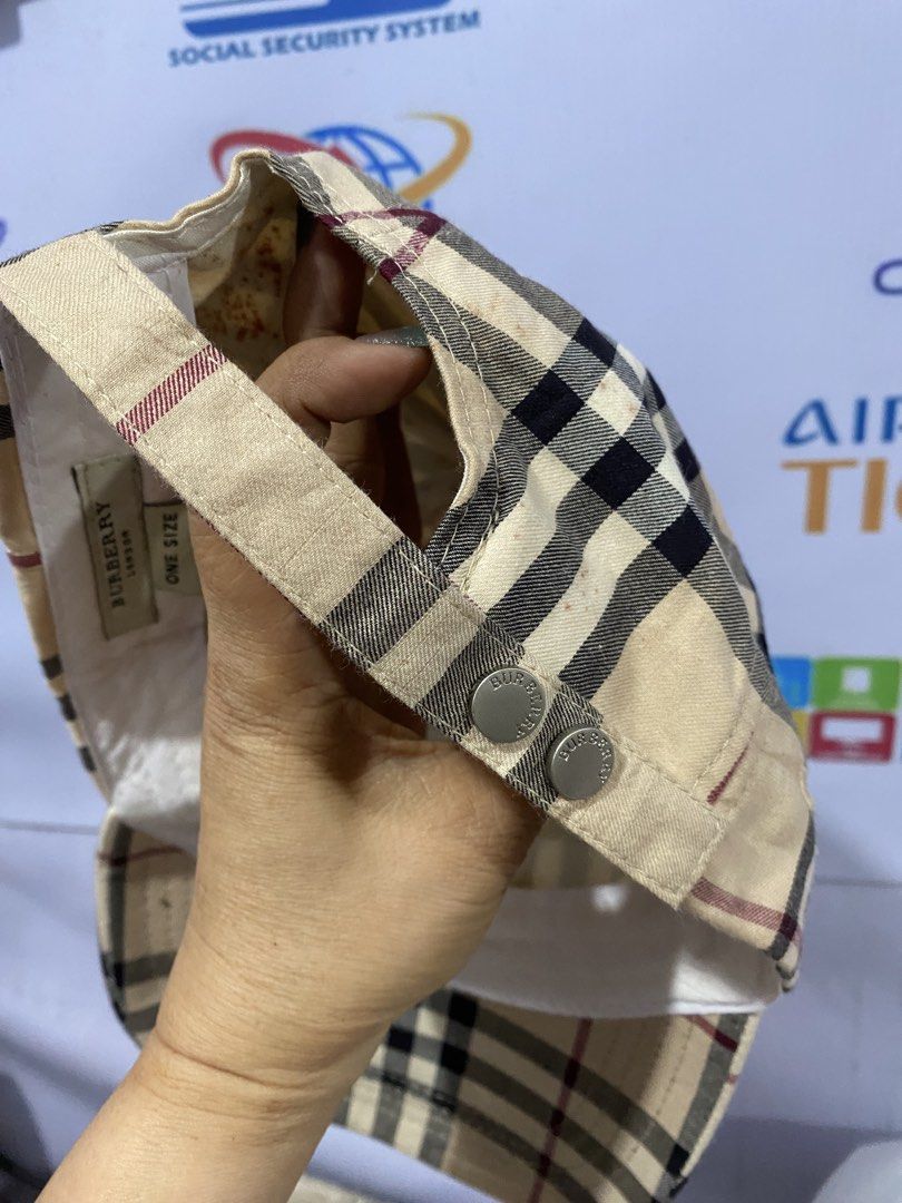 Burberry London Classic Check Cap (Category: Caps & Hats) located in Bacolod City. Submitted by chuchaystuffs (Listing ID 1469217634, Image 3). Description: - Brand: Burberry London - Pattern: Classic beige, black, and red check - Size: One size fits all with adjustable strap - Hardware: Silver-tone metal snap buttons with Burberry logo - Interior: White sweatband with Burberry London tag - Condition: Noticeable staining and discoloration inside 