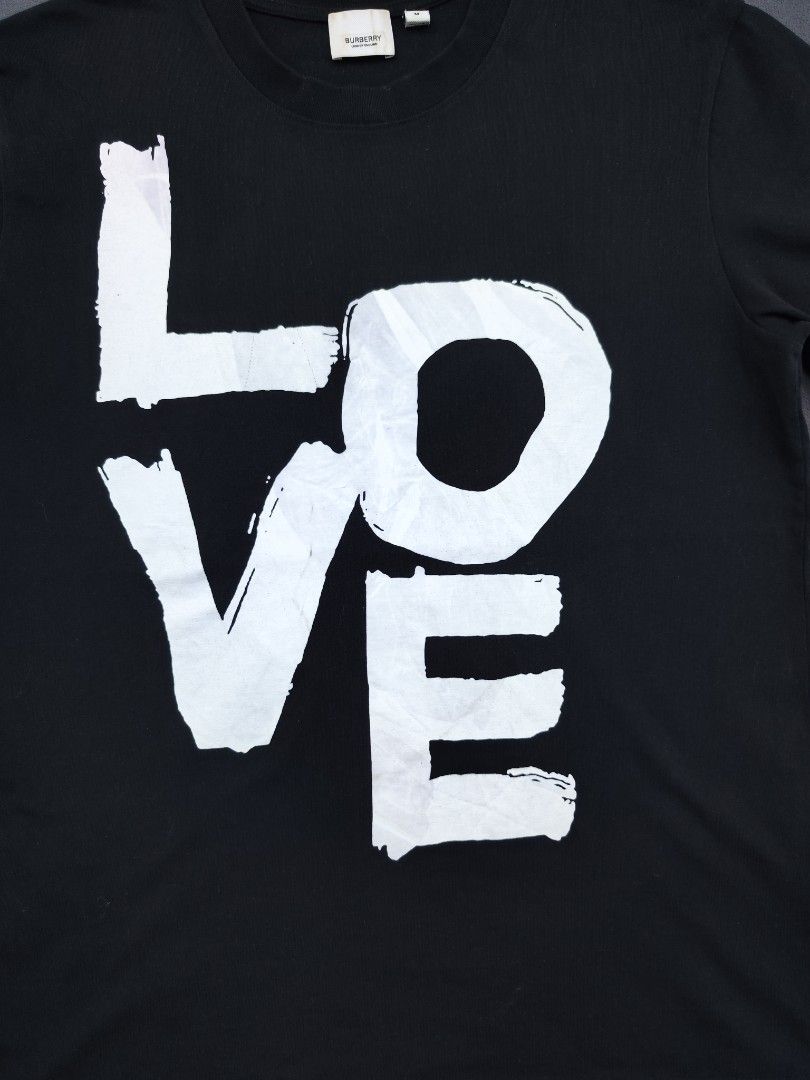 Burberry Love Tee (Category: Luxury Apparel) located in Bulacan. Submitted by emilj23 (Listing ID 1469199059, Image 2). Description: Burberry Love Tee Size M on tag L 26 W 20 Condition 9/10 Color rate 9/10 Issue Print Stains,Pinhole.