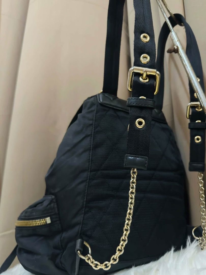 Burberry Nylon & Leather Rucksack (Category: Backpacks) located in Santiago. Submitted by evrythngulove (Listing ID 1469335430, Image 3). Description: Authentic black nylon Burberry backpack featuring chic tan leather trim and gold hardware. Includes a drawstring main compartment, multiple outer zip pockets, and comfortable adjustable straps. Perfect for everyday luxury!.
