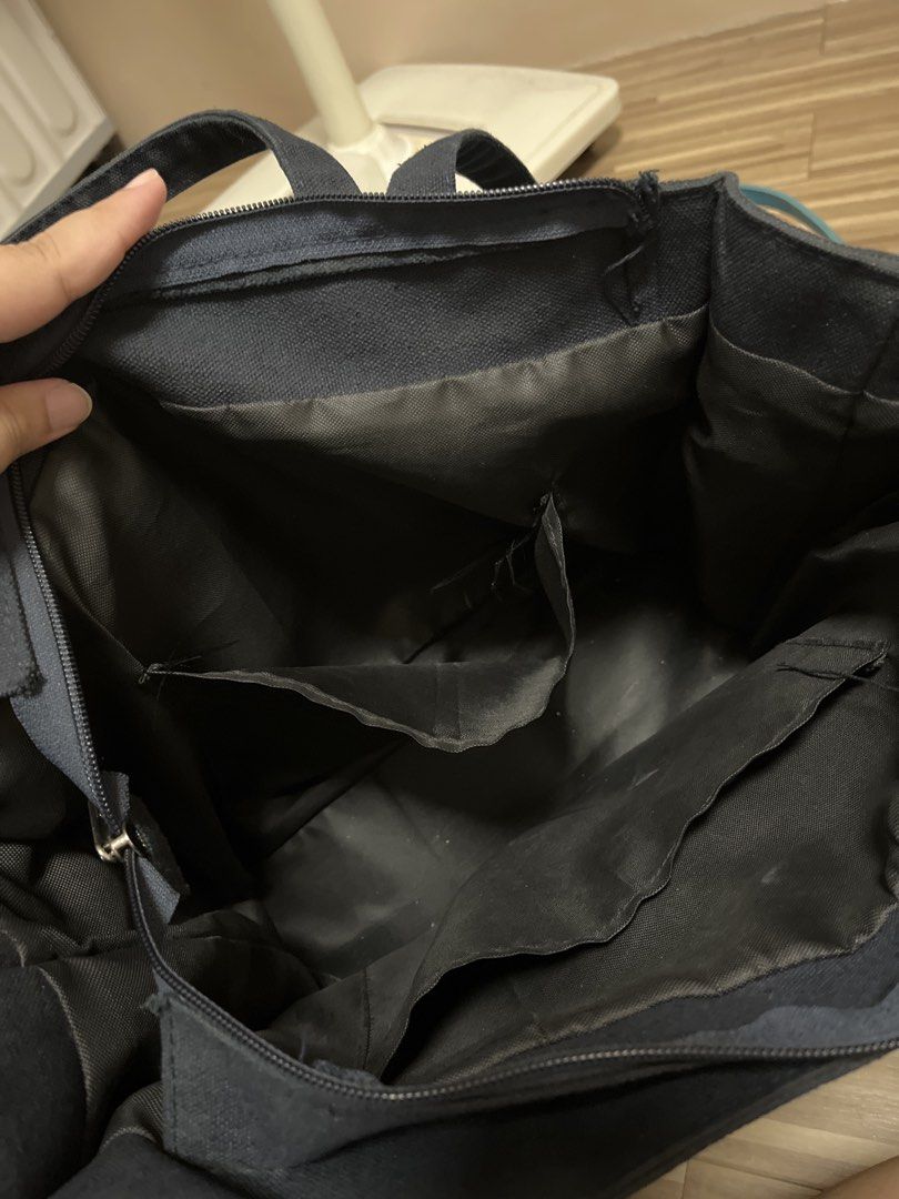 byBTG Boxy Tote (Category: Tote Bags) located in Cardona. Submitted by minyoonji (Listing ID 1469263133, Image 3). Description: - Brand: byETG - Material: Durable black canvas - Design: Structured shape with sturdy double straps and top zipper closure - Exterior: Deep front pockets for quick access - Interior: Multiple compartments and practical slip pockets for easy organization - Condition: Minimal wear, clean inner lining.
