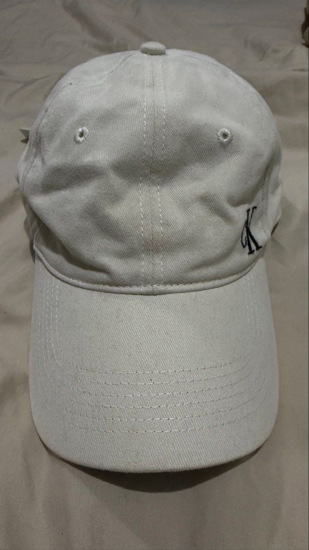 Calvin Klein Baseball Cap (Category: Caps & Hats) located in Makati City. Submitted by clutterfreejia (Listing ID 1469224879, Image 2). Description: Store bought at ₱1600 Color: cream / light beige Needs cleaning / wash No flaws other than the stains due to storage Rfs: decluttering.
