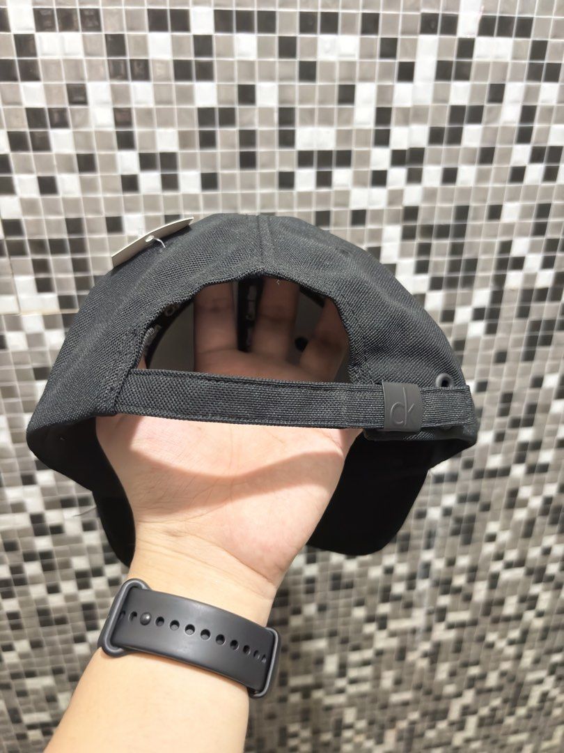 Calvin Klein Jeans Black Baseball Cap (Category: Caps & Hats) located in General Trias. Submitted by nomeeer (Listing ID 1469164140, Image 3). Description: - Brand: Calvin Klein Jeans - Color: Classic Black - Style: Curved brim baseball cap - Branding: Embroidered logo on front and repeated text on interior taped seams - Fit: Adjustable back strap with branded metal buckle - Condition: Clean, excellent pre-owned condition.