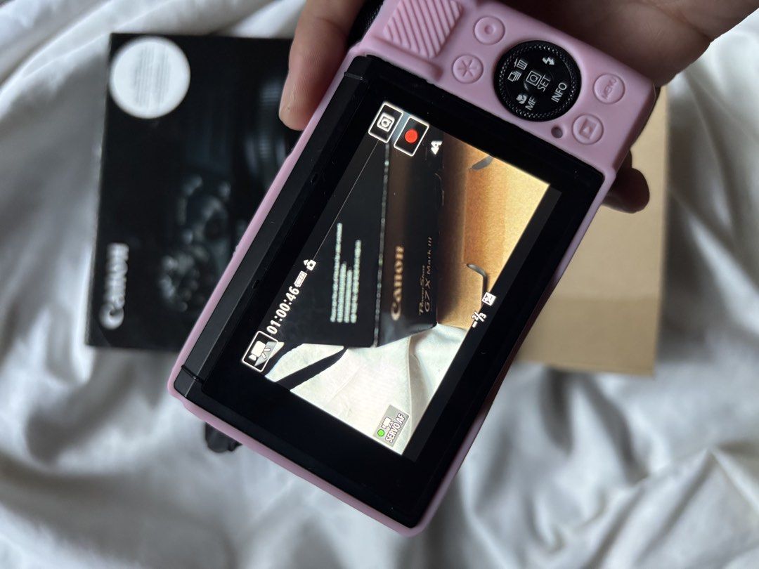 Canon PowerShot G7 X Mark III Digital Camera Pink (Category: Cameras) located in Mandaluyong City. Submitted by mini.declutter (Listing ID 1469385021, Image 2). Description: - Camera Model: Canon PowerShot G7 X Mark III - Condition: Fully operational with a clear live-view LCD screen - Included: Pink silicone protective case and original retail box - Ideal For: Everyday shooting, traveling, and vlogging - Portability: Compact and pocket-sized des