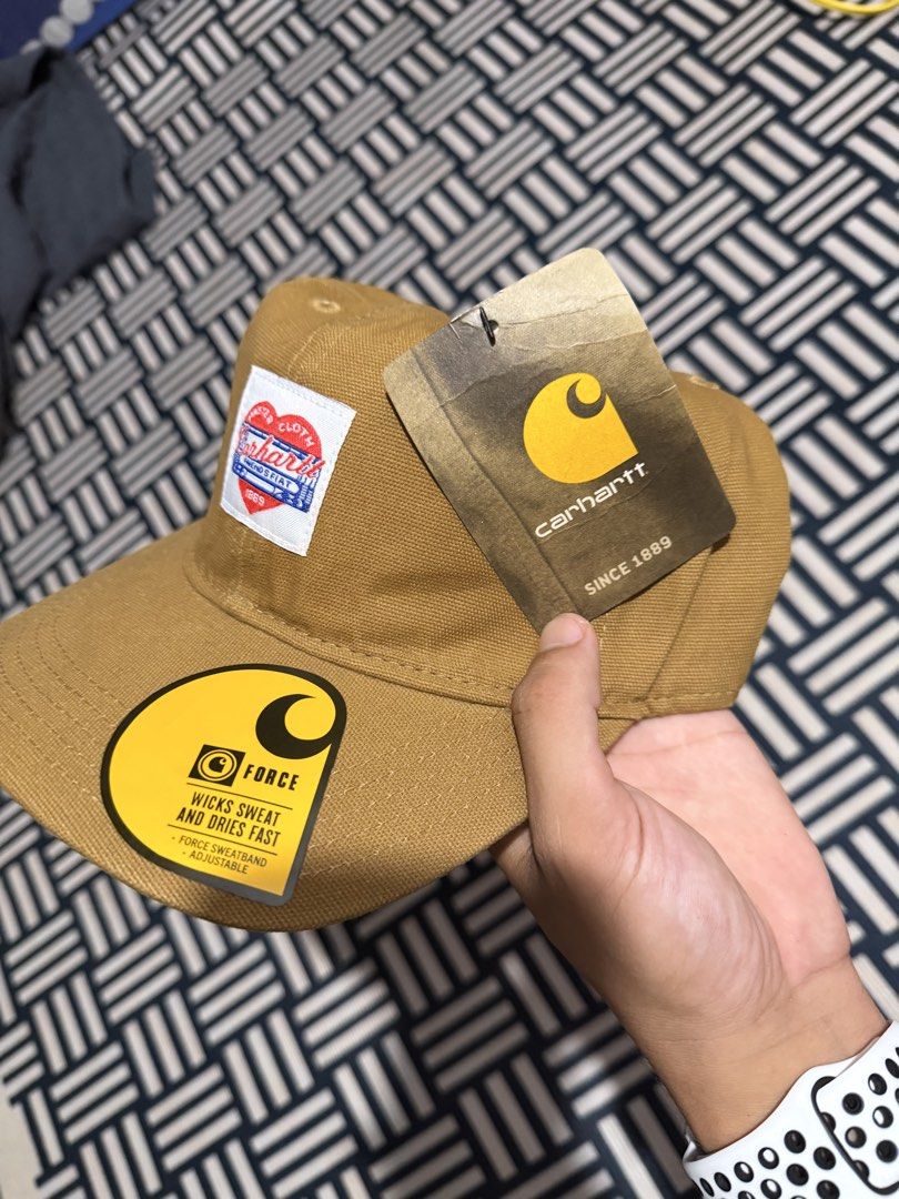 Carhartt WIP Force Cap Brown with Heart Patch (Category: Caps & Hats) located in Manila. Submitted by garcianath68674 (Listing ID 1469285556, Image 3). Description: - Brand new with original tags attached - Color: Classic brown canvas - Rare special edition heart patch logo on the front - Built-in Force sweatband wicks sweat and dries fast - Adjustable strap closure with iconic Carhartt yellow logo tag - One size fits all.