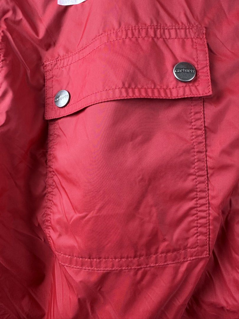 Carousell Carhartt Red Hooded Zip Jacket (Category: Coats, Jackets and Outerwear) located in Manila. Submitted by declutterpromax (Listing ID 1469223225, Image 3). Description: - Brand: Carhartt - Color: Bright red - Features: YKK front zipper closure, dual chest flap pockets with branded snap buttons, mesh-lined hood - Details: Iconic Carhartt logo patch on the lower left pocket - Measurements: 22" (chest) x 24" (length) x 21" (sleeves) - Style:
