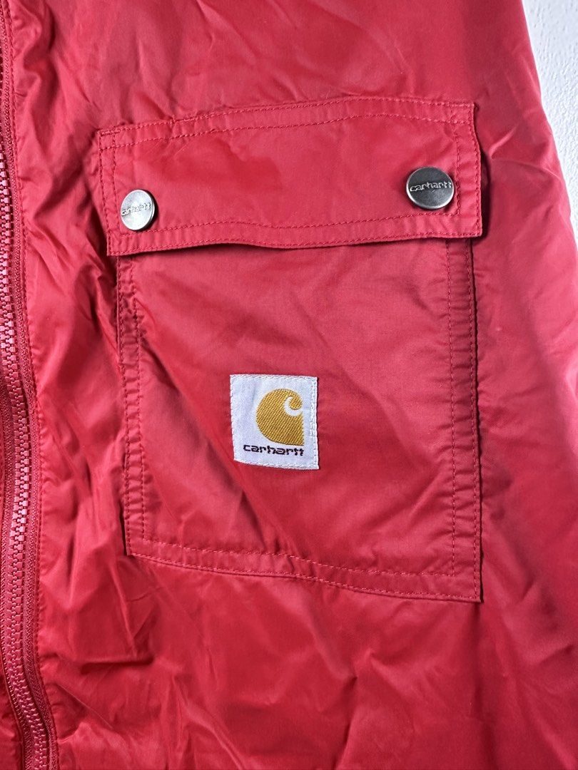Carousell Carhartt Red Hooded Zip Jacket (Category: Coats, Jackets and Outerwear) located in Manila. Submitted by declutterpromax (Listing ID 1469223225, Image 2). Description: - Brand: Carhartt - Color: Bright red - Features: YKK front zipper closure, dual chest flap pockets with branded snap buttons, mesh-lined hood - Details: Iconic Carhartt logo patch on the lower left pocket - Measurements: 22" (chest) x 24" (length) x 21" (sleeves) - Style:
