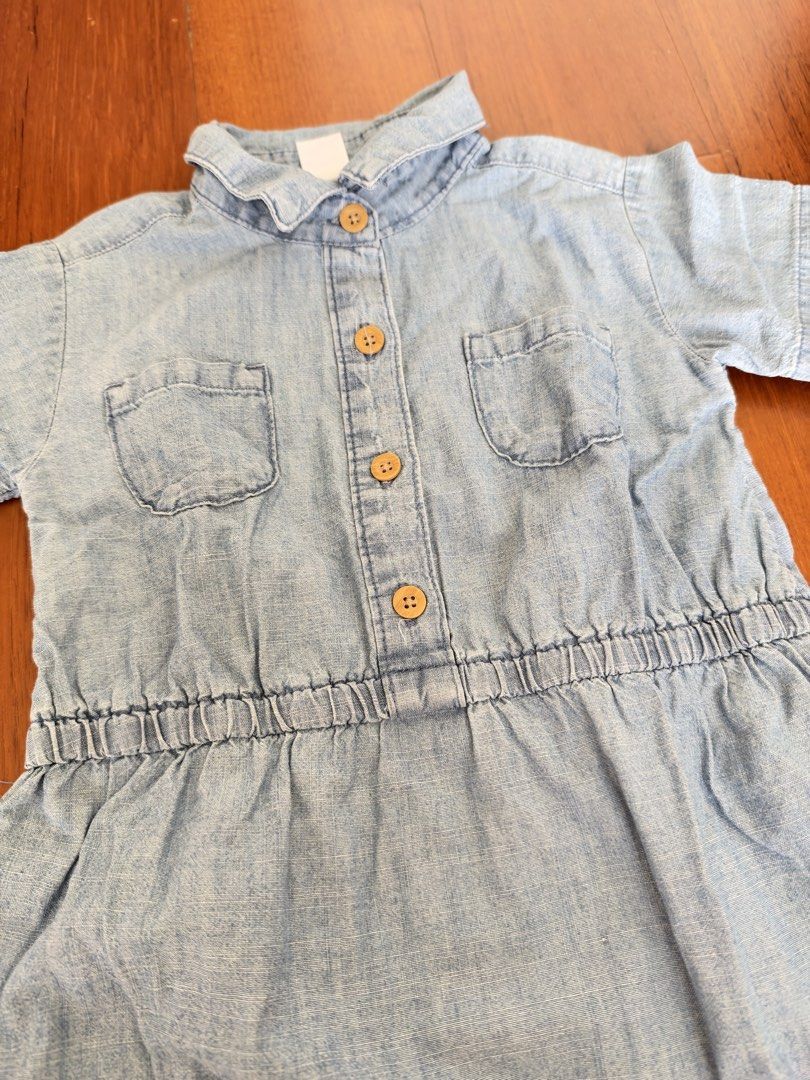 Carter's Kid Denim Dress (Category: Babies & Kids Fashion) located in Quezon City. Submitted by valbanz (Listing ID 1469183310, Image 2). Description: - Brand: Carter's - Item: Kid Denim Dress - Color: Light Blue - Size: 5 / 5A - Material: 100% cotton - Features: Short sleeves, button-down front with wooden buttons, two chest pockets, comfortable elasticized waist - Condition: Pre-loved, with a small faint stain near the collar lining.