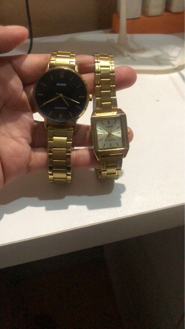 Casio Gold Watch Pair - Round Black & Square White (Category: Women's Watches) located in Manila. Submitted by camron08 (Listing ID 1469272584, Image 2). Description: Pair of pre-loved Casio gold-tone watches sold as a set. Includes one round black-dial watch and one square champagne-dial watch, both with metal link bracelets and water-resistant builds. Shows normal signs of everyday wear..