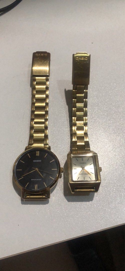 Casio Gold Watch Pair - Round Black & Square White (Category: Women's Watches) located in Manila. Submitted by camron08 (Listing ID 1469272584, Image 1). Description: Pair of pre-loved Casio gold-tone watches sold as a set. Includes one round black-dial watch and one square champagne-dial watch, both with metal link bracelets and water-resistant builds. Shows normal signs of everyday wear..