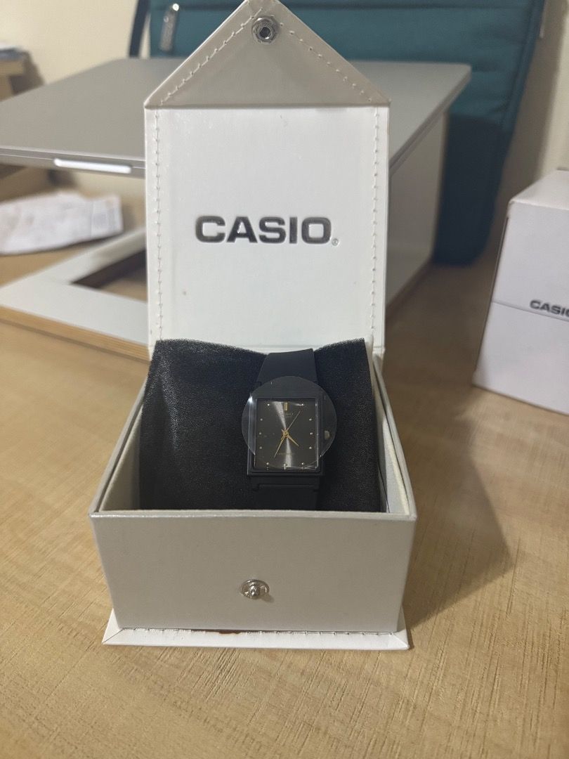 Casio Quartz Black Rectangular Watch in Box (Category: Women's Watches) located in Pasig City. Submitted by daryl.s.preloved_ (Listing ID 1469274852, Image 2). Description: - Brand: Casio - Condition: Brand new, never worn with plastic protective film still on the face - Dial: Rectangular black dial with elegant gold hands - Strap: Simple and classic black strap - Packaging: Comes complete in its original white Casio presentation box on a black d