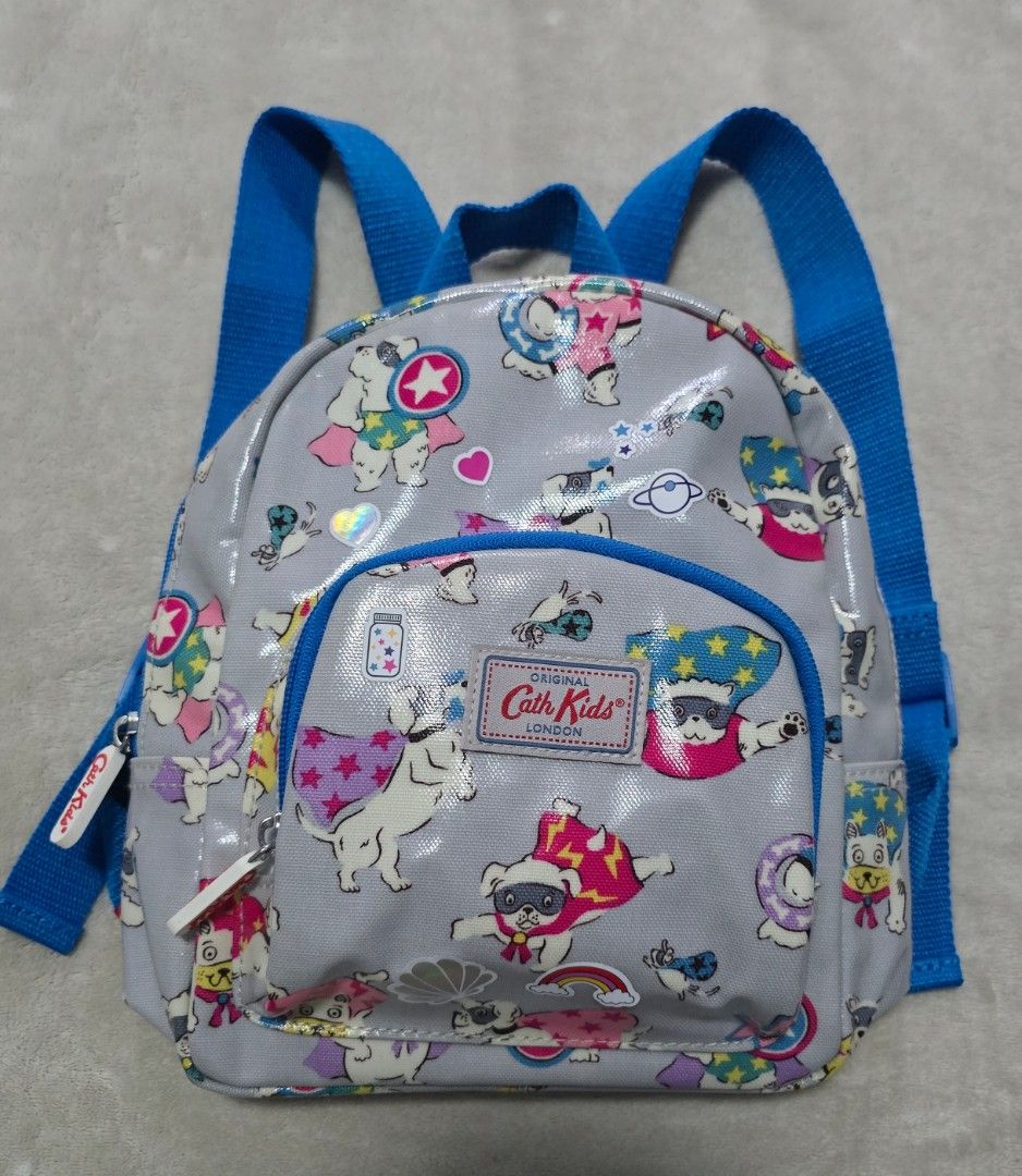 Cath Kidston Kids Super Dog Backpack Grey Blue (Category: Babies & Kids Fashion) located in Pasig City. Submitted by bravegem.9fcc5c (Listing ID 1469279252, Image 1). Description: - Authentic Cath Kidston Kids mini backpack gift from London - Fun all-over super dog print on grey backgroundi - Bright blue adjustable straps for a pop of color - Handy front zip pocket for small essentials - Shiny, wipe-clean finish for easy maintenance - Ideal size 