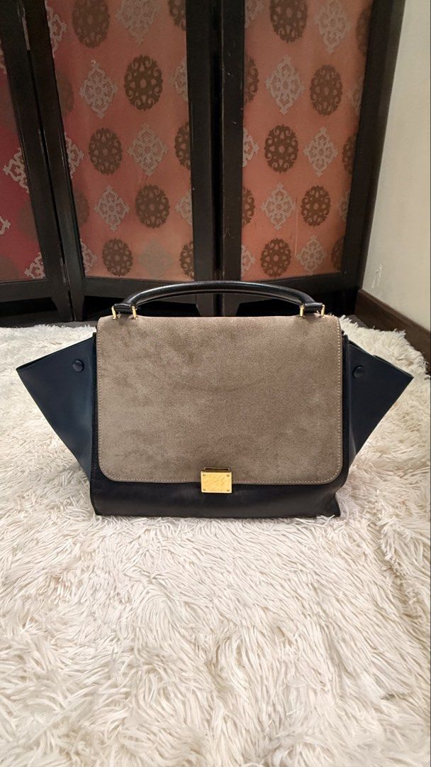 Celine Tricolor Trapeze Bag (Category: Luxury Bags & Wallets) located in Pasay City. Submitted by erinsclosetph (Listing ID 1469292142, Image 1). Description: Celine Tricolor Trapeze Bag Beautiful Celine Trapeze in a chic combination of navy blue, light brown suede, and black leather. Comes with a detachable leather shoulder strap for versatile styling. Color: Navy blue, light brown suede, and black Condition: Pre-loved with signs of wear Hardwar