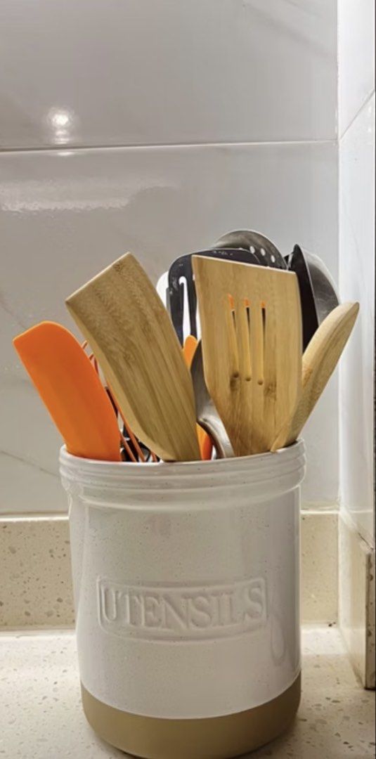 Ceramic Utensil Holder (Category: Food Organization & Storage) located in Manila. Submitted by prelovedpick.com (Listing ID 1469211122, Image 2). Description: New ‼️ Never been used Photos are for inspo - Ceramic utensil crock in white with speckled finish and tan base - Features embossed 'UTENSILS' text on the front - Keeps countertops neat and organized - Stylish design fits any kitchen decor.