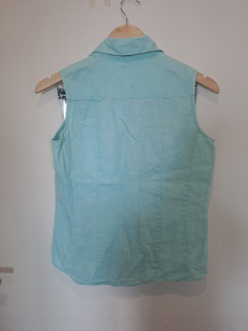 Chadwick 100% linen (Category: Sleeveless) located in Manila. Submitted by joanbalde39643 (Listing ID 1469204768, Image 3). Description: The garment in the image is a vintage Chadwick's sleeveless button-up blouse. It features a pointed spread collar, a structured front button placket with matching translucent buttons, and vertical shaping darts down the bodice for a tailored fit..