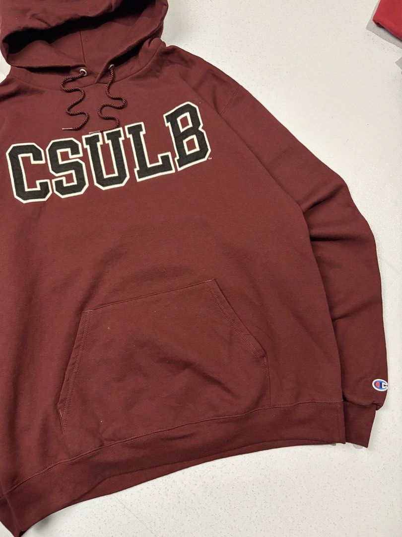 Champion CSULB Maroon Hoodie Size L (Category: Hoodies) located in Cainta. Submitted by rizalthriftstuff (Listing ID 1469317201, Image 2). Description: Champ CSULB Hoodie Fave 🔥🔥🔥 Dimes Size: L Width: 23 Length: 27 Color Rate: 10 Condition: 9 No Issue Mine - ₱800 - Brand: Champion - Color: Maroon - Design: CSULB appliquéd across the chest - Size: Large - Features: Drawstring hood, front kangaroo pocket, ribbed cuffs - Details: Iconic embroider