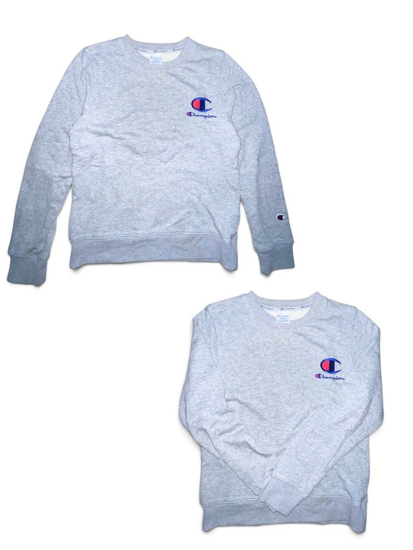 Champion Grey Crewneck Sweatshirt Size S (Category: Coats, Jackets and Outerwear) located in Binan City. Submitted by huntwear_.turtle (Listing ID 1469167665, Image 1). Description: - Brand: Champion - Style: Crewneck sweatshirt - Color: Light grey marl - Size: Small (Regular fit) - Details: Embroidered script logo on chest, iconic 'C' patch on left sleeve - Features: Ribbed cuffs and hem for a snug fit - Condition: Great for casual everyday wear
