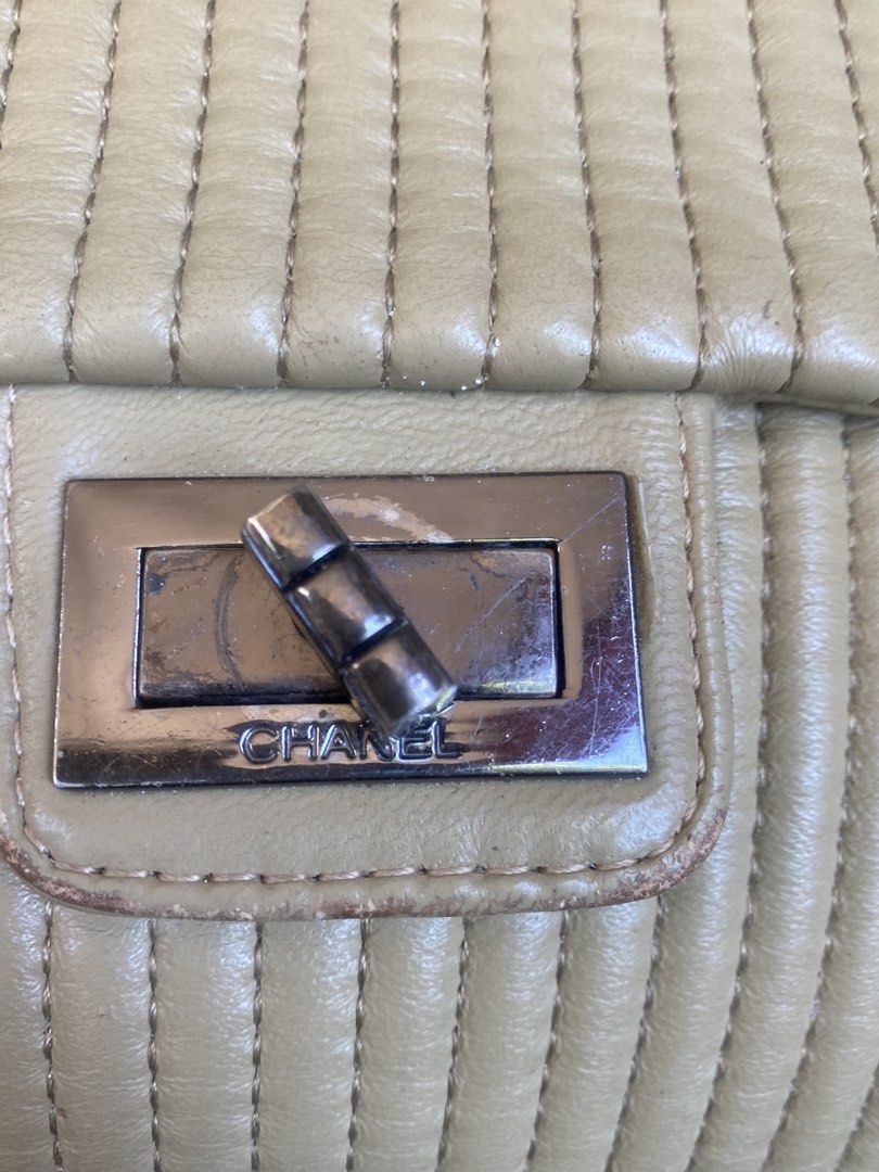 Chanel Quilted Leather Shoulder Bag (Category: Luxury Bags & Wallets) located in Bacolod City. Submitted by chuchaystuffs (Listing ID 1469168249, Image 2). Description: - Brand: Chanel - Style: Quilted shoulder bag with structured flap - Material: Pale beige leather - Hardware: Gunmetal with interlocking chain strap - Closure: Rectangular turn-lock with engraved Chanel name - Design: Vertical channel quilting throughout - Condition: Good pre-owne