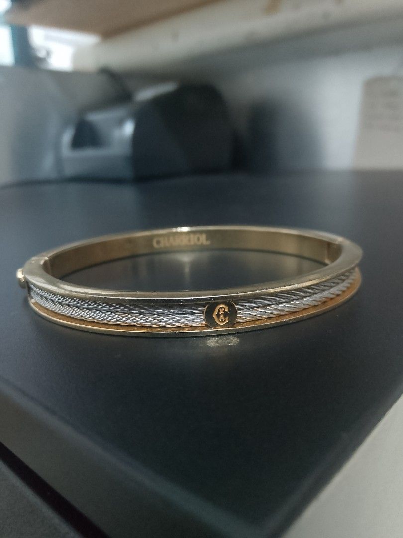 Charriol Two-Tone Cable Bangle Bracelet (Category: Bracelets) located in Manila. Submitted by gillianest44494 (Listing ID 1469197895, Image 2). Description: - Authentic Charriol bangle bracelet - Elegant two-tone gold and silver finish - Signature twisted cable design with smooth inner band - Secure hinged clasp closure - Features engraved interior branding and front logo plaque - Timeless luxury piece, perfect for daily wear or gifting.