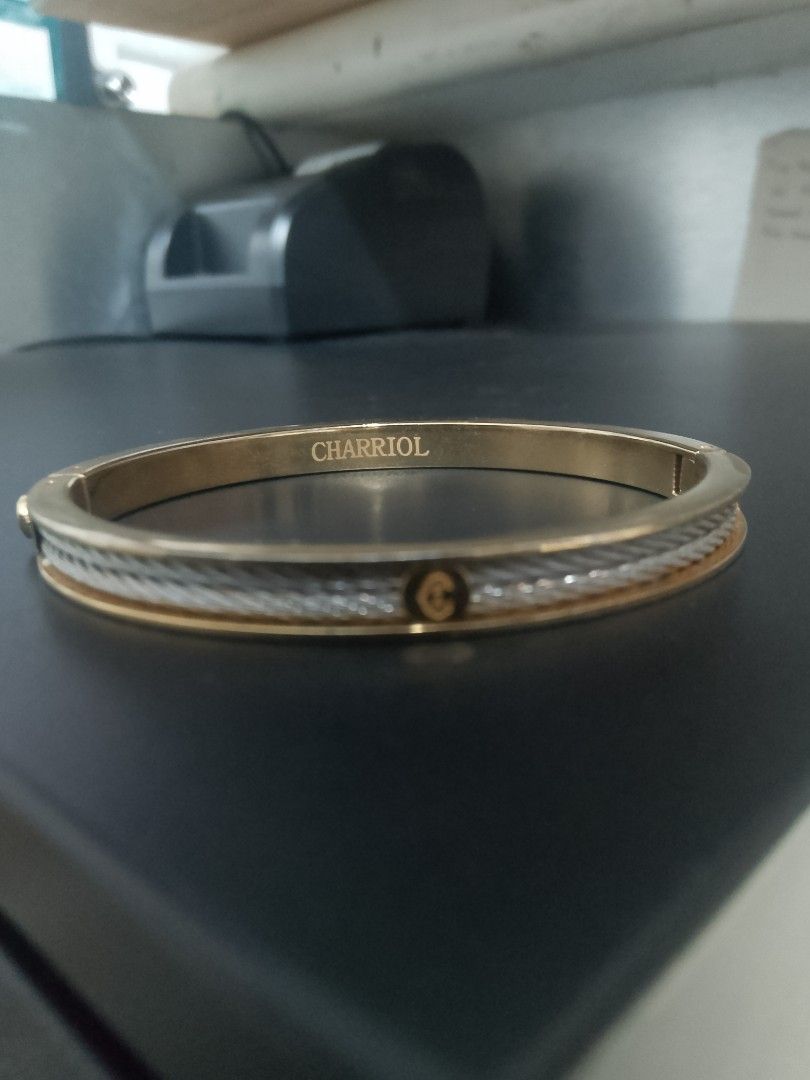 Charriol Two-Tone Cable Bangle Bracelet (Category: Bracelets) located in Manila. Submitted by gillianest44494 (Listing ID 1469197895, Image 3). Description: - Authentic Charriol bangle bracelet - Elegant two-tone gold and silver finish - Signature twisted cable design with smooth inner band - Secure hinged clasp closure - Features engraved interior branding and front logo plaque - Timeless luxury piece, perfect for daily wear or gifting.