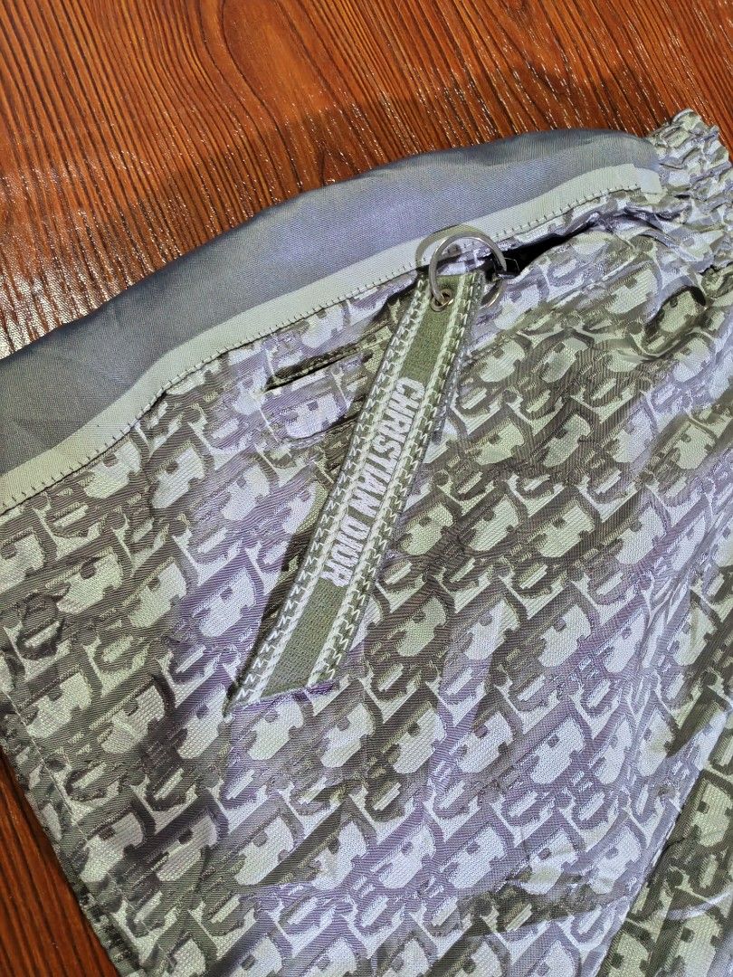 CHRISTIAN DIOR OBLIQUE MONOGRAM SHORT (Category: Shorts) located in Quezon City. Submitted by unholy_finds (Listing ID 1469286246, Image 3). Description: - Brand: Christian Dior - Color: Grey with all-over oblique monogram print - Waistband: Comfortable elastic fit - Details: Side stripes with bold Dior lettering - Pocket: Functional side zip pocket with branded ribbon pull tab - Material: Smooth fabric with a slight sheen - Condition: Clean and 